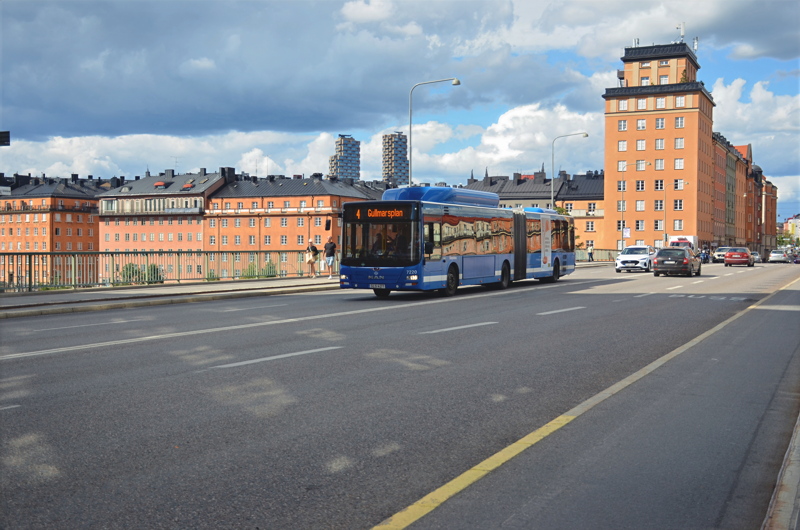 13 - A Stockholm Public Transport (SL) bus traveling along a city street lined with traditional architecture